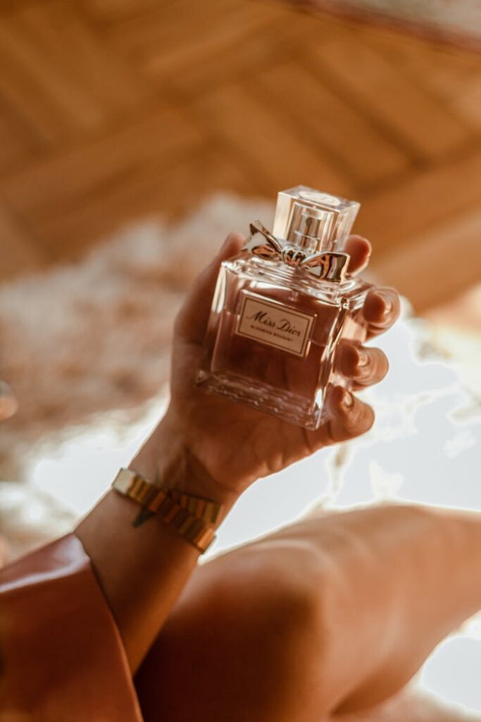 Stylish woman holding a luxurious perfume bottle, exuding elegance and fragrance.
