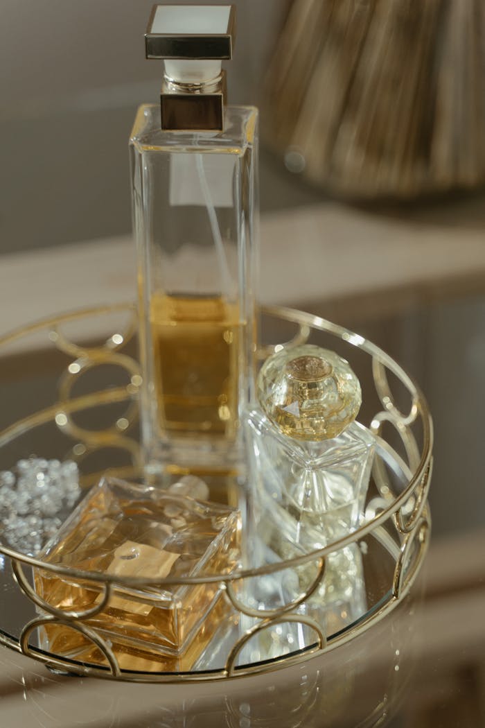 Luxurious perfume bottles elegantly arranged on a decorative tray, showcasing sophistication.