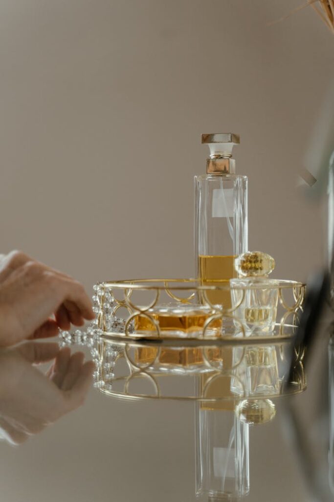 Luxurious perfume bottle on a golden tray with reflection, elegant and stylish.